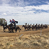 The troop are escorted into Barcaldine before the mounted street parade.