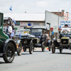 A group of Model T Ford vintage cars from the era participate in the march.