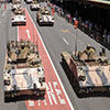 Armoured tanks moving through Brisbane city streets.